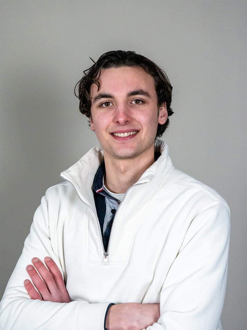 Multi-ethnic business team descending stairs, discussing work in a bright, modern office space