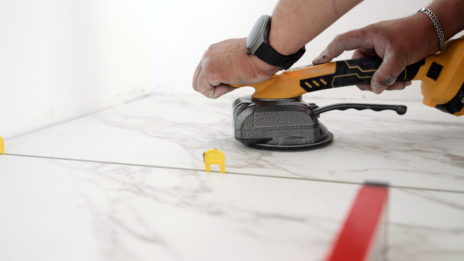 Tiler using leveling system for marble tiles