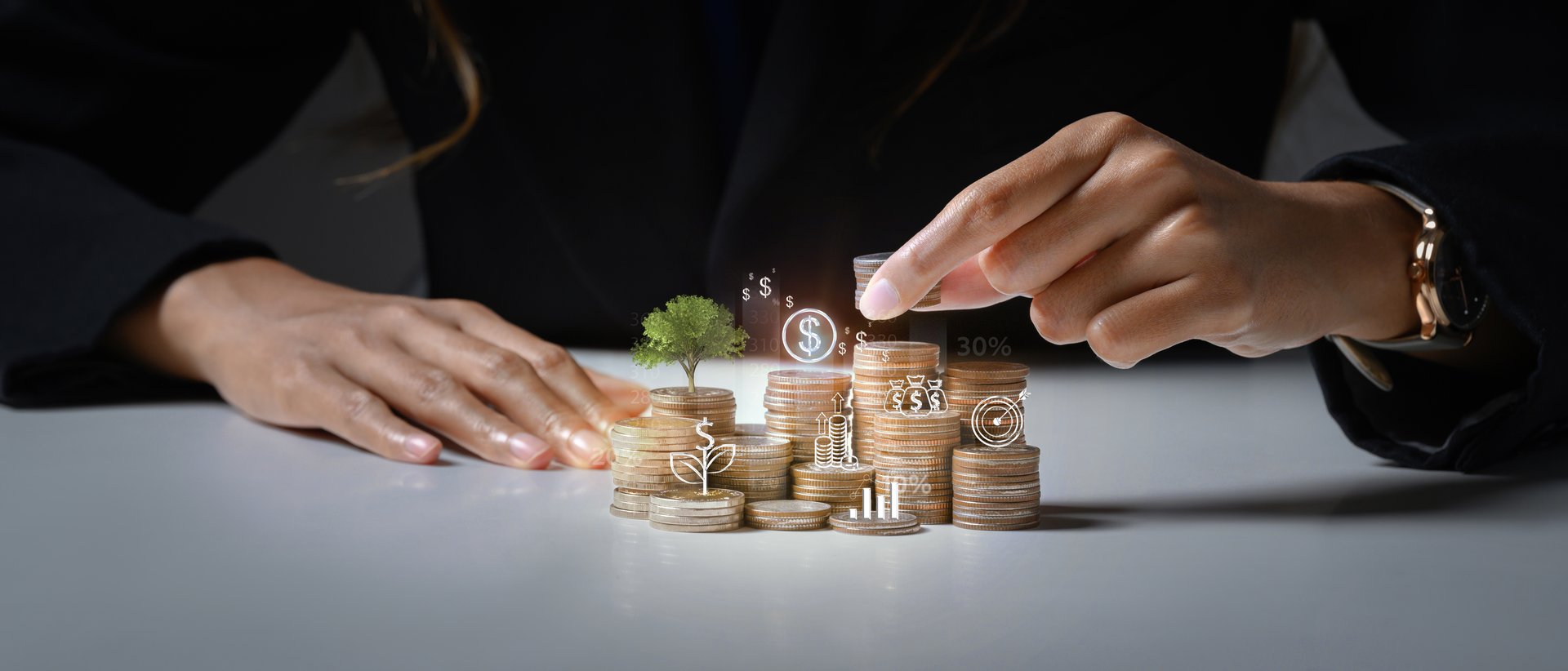 Businessman putting coin on stack with growing small tree symbolizing investment growth and saving money.