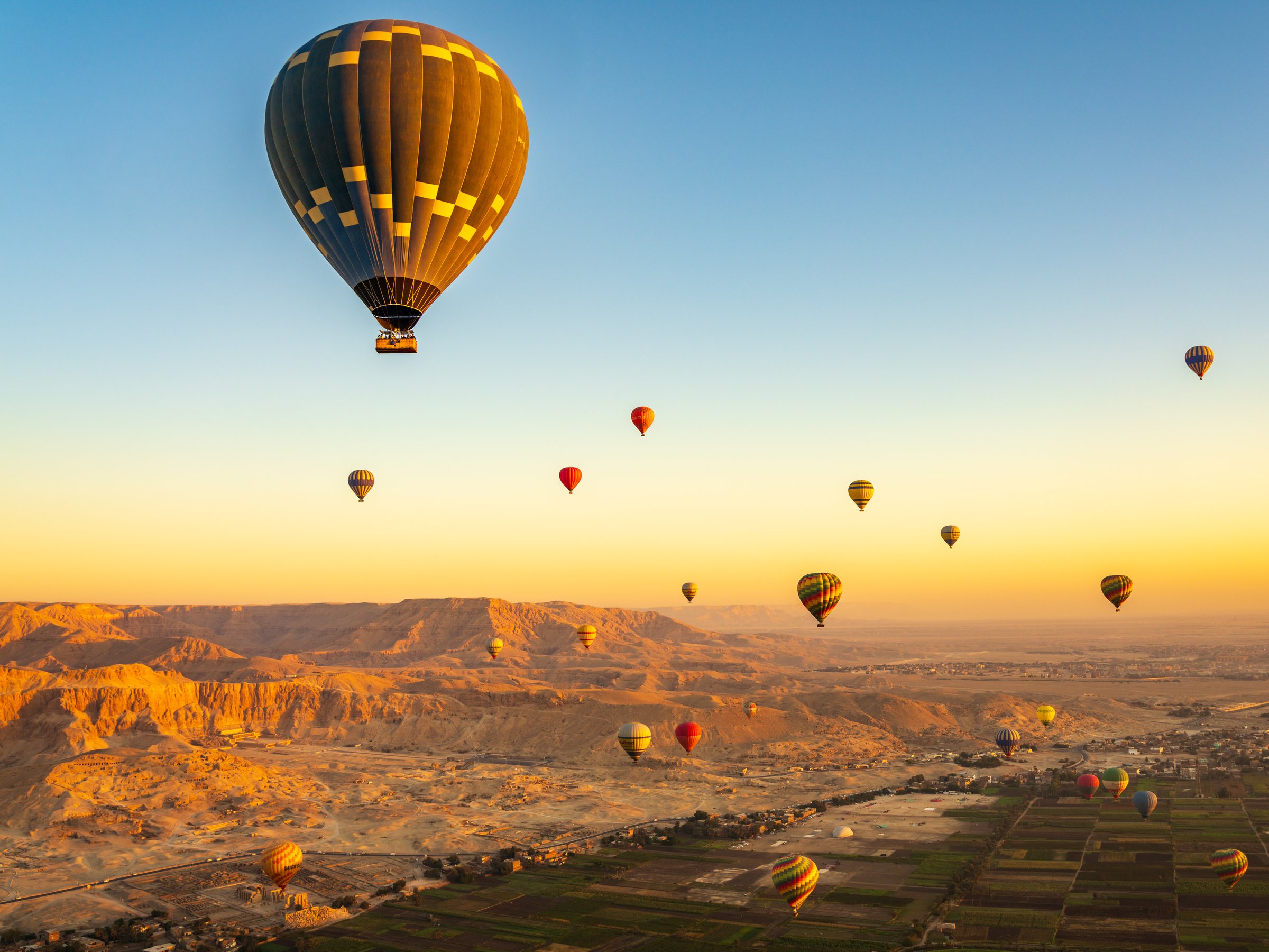 Hot-air balloons over Temple of Hatshepsut at Deir el Bahari and Valley of Kings near Luxor, Egpyt
