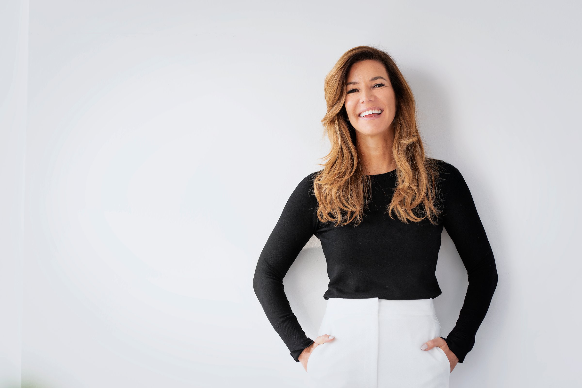 Portrait of smiling businesswoman. Female entrepreneur standing against isolated background. Blond haired female wearing smart casual against and smiling. Copy space.