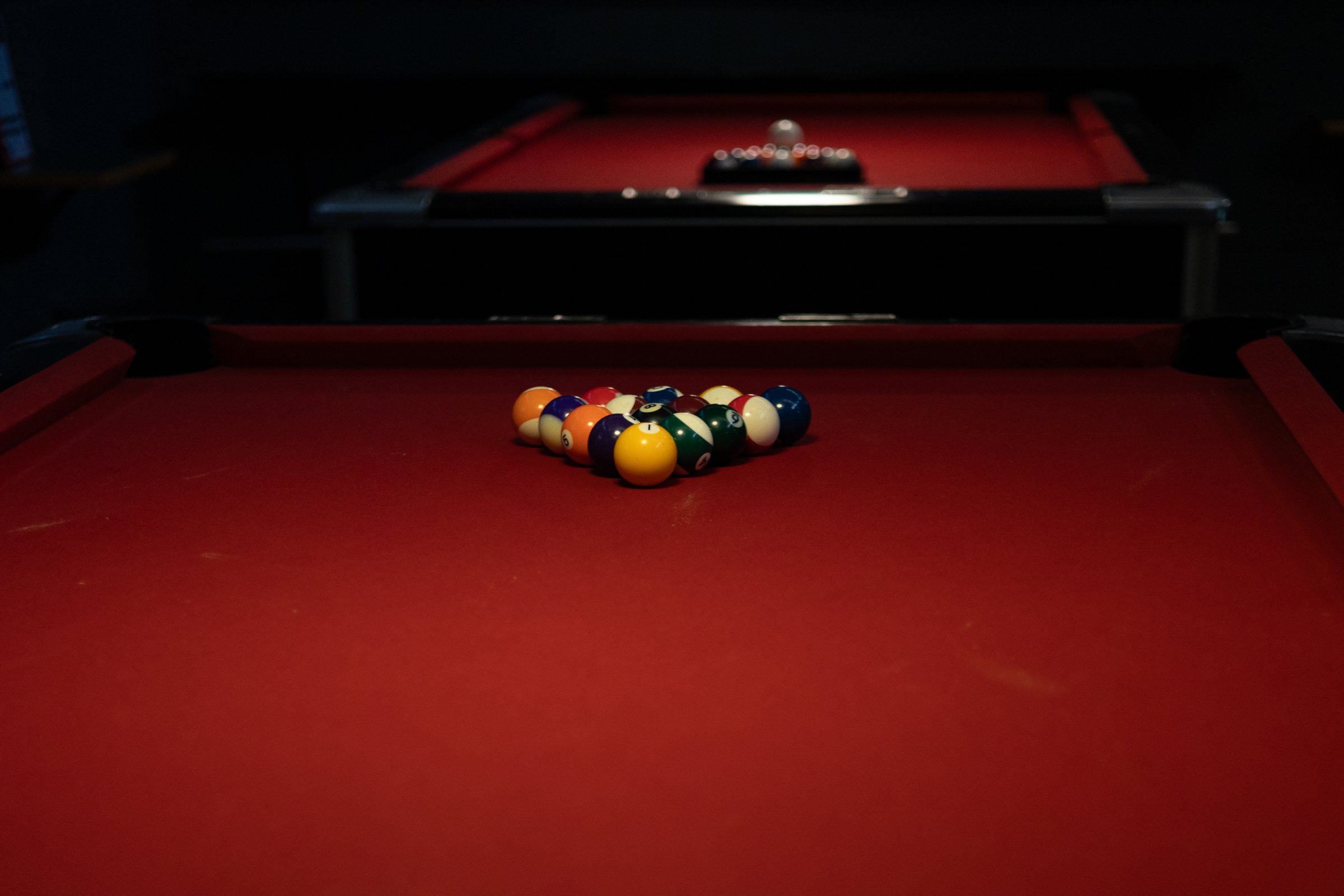 play with billiard balls ready to play on a red table