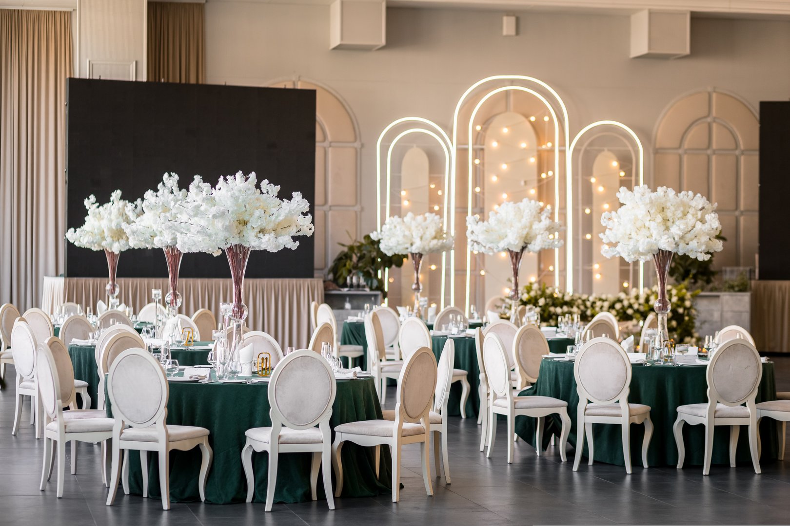 Restaurant tables decoration on golden lights with digital screen background.