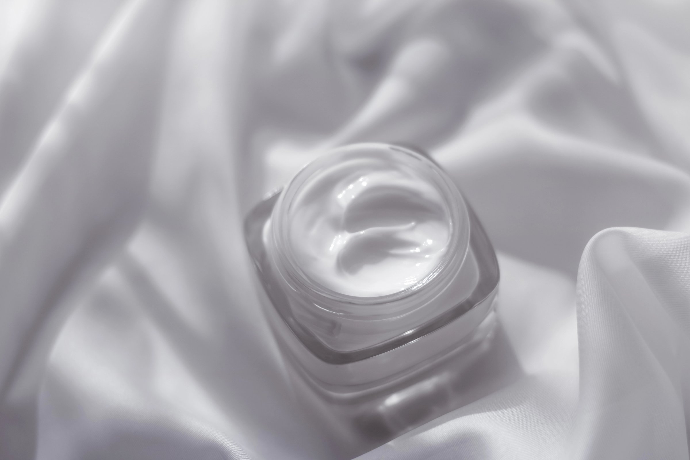 Cosmetic branding, toiletries and spf concept - Face cream moisturizer jar on silk background, moisturizing skin care lotion and lifting emulsion, anti-age cosmetics for luxury beauty skincare brand
