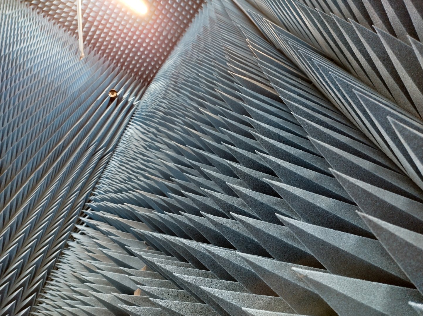 Soundproofing foam pyramid panels in acoustic treatment room for noise reduction