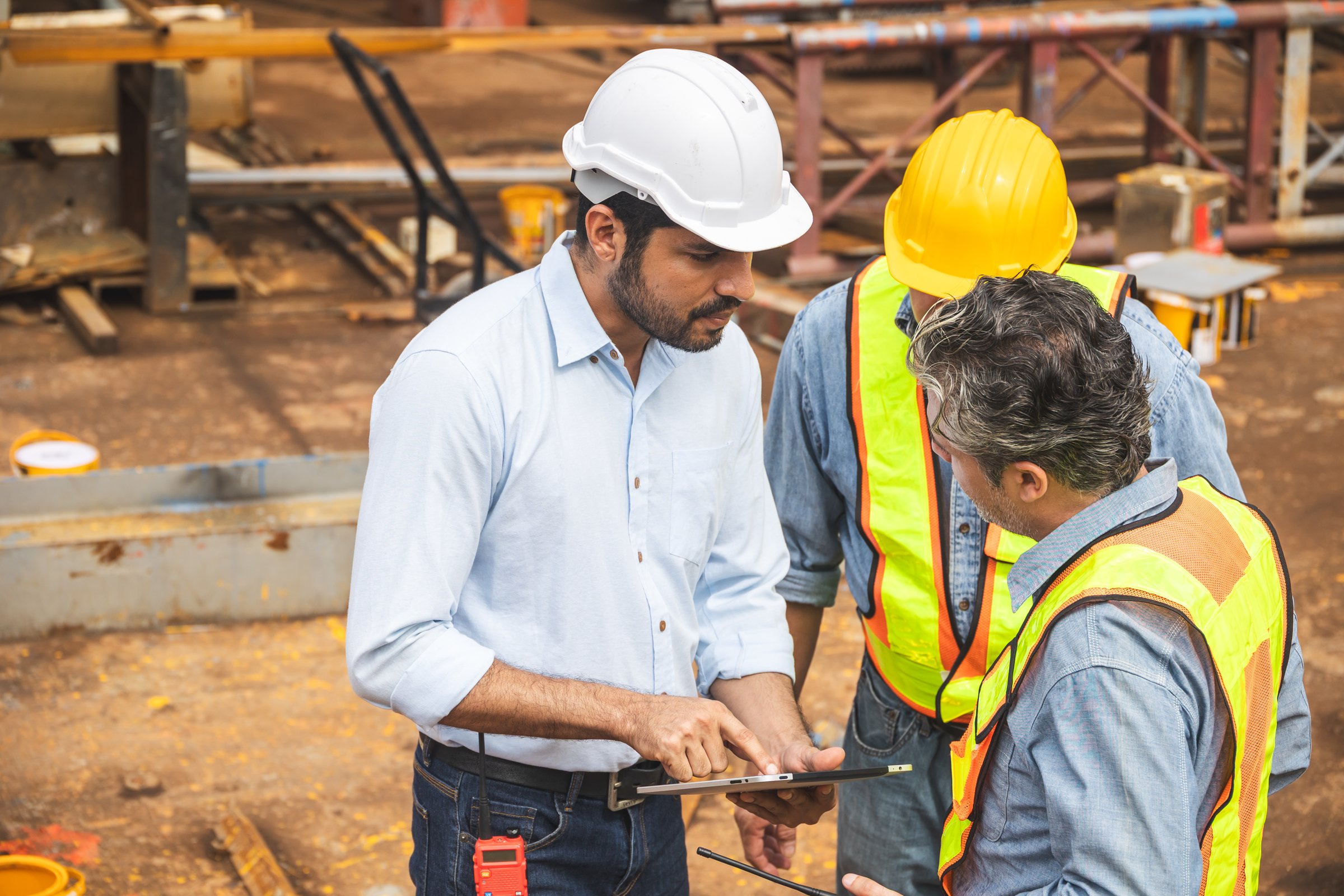 Construction engineer team working together join teamwork talking together at construction site planning project with on tablet computer