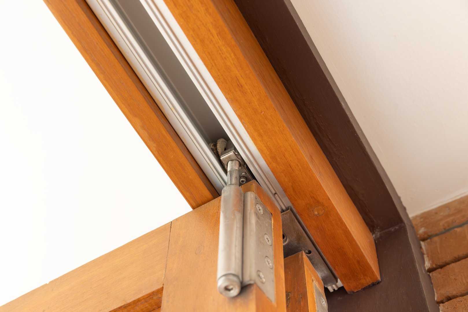 Top hung bifold system for large door panels.