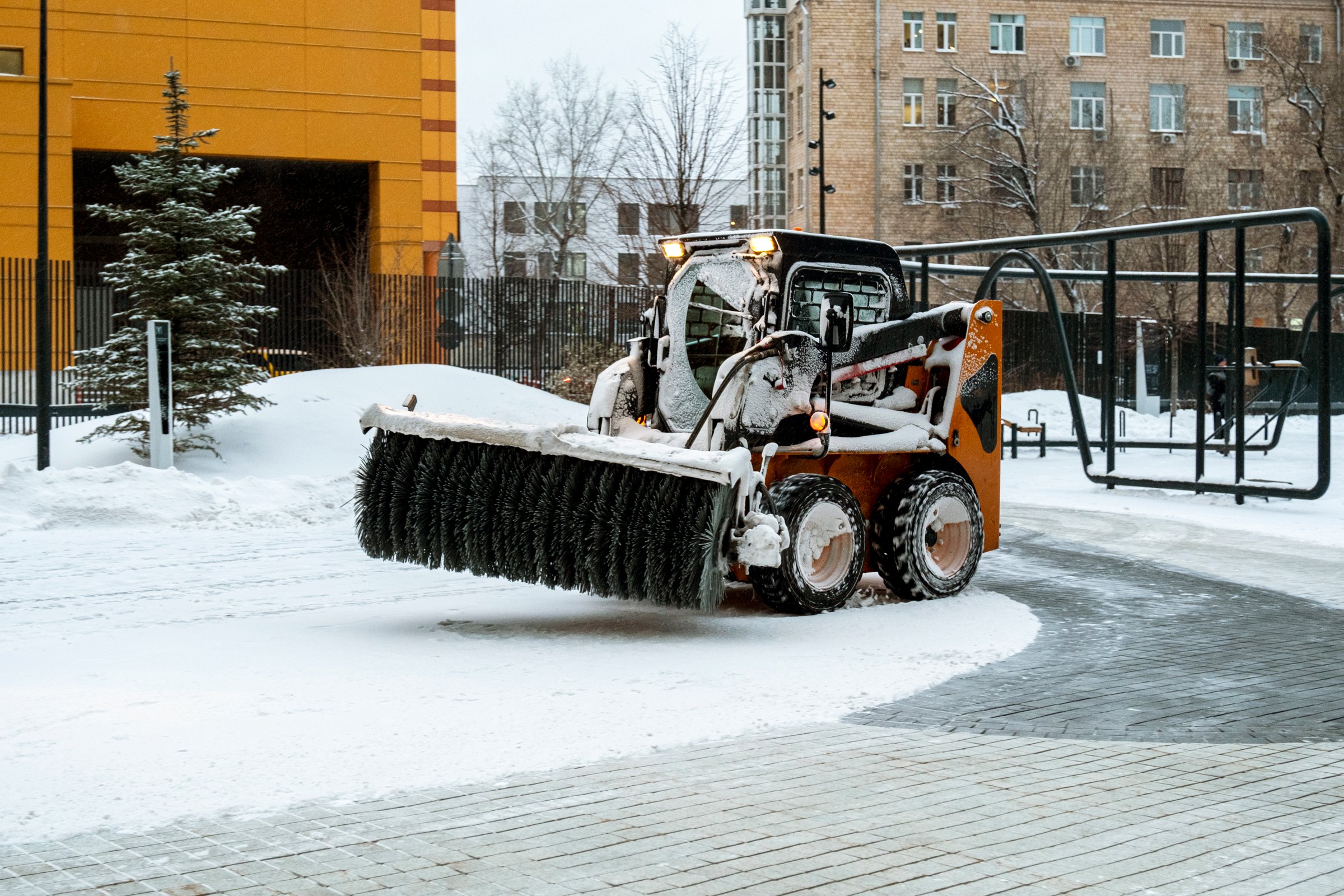 Snow removal equipment clearing snow from a residential area, showcasing professional machinery for efficient winter service in Anchorage.