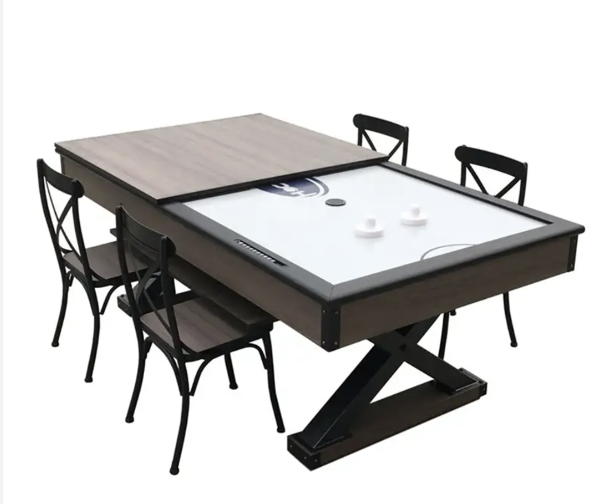 Convertible table with air hockey surface and wooden top, surrounded by four black chairs on a white background.