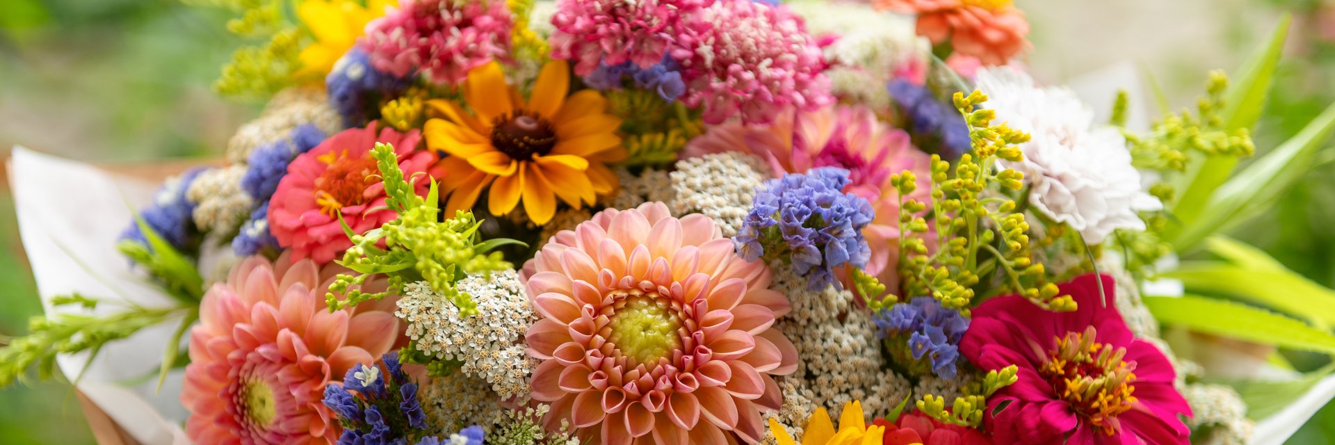 Summer bouquet. Beautiful multi colored fresh flower arrangement. Birthday bouquet made of summer flowers photographed outdoors.