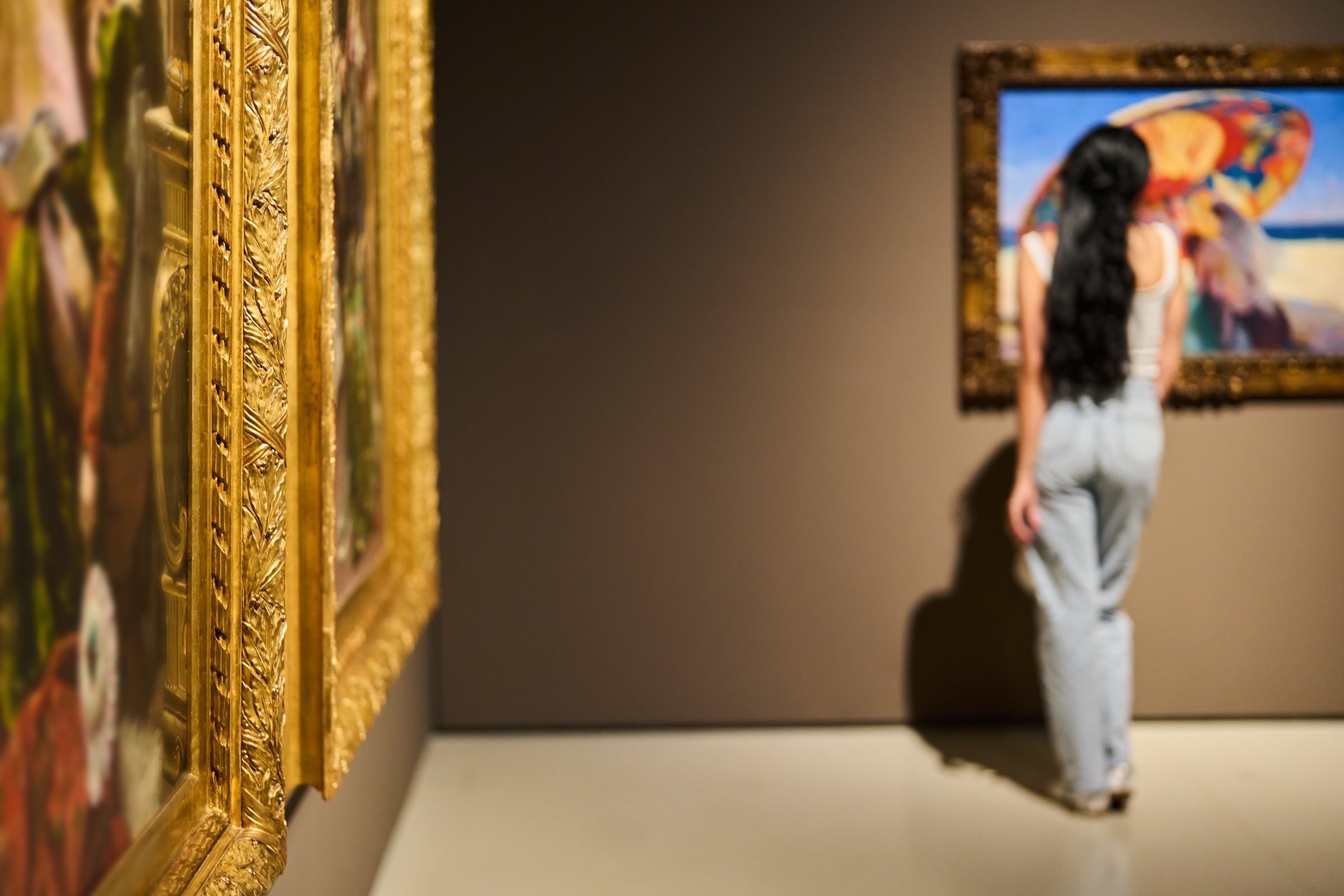 background women in the museum looks at art gallery