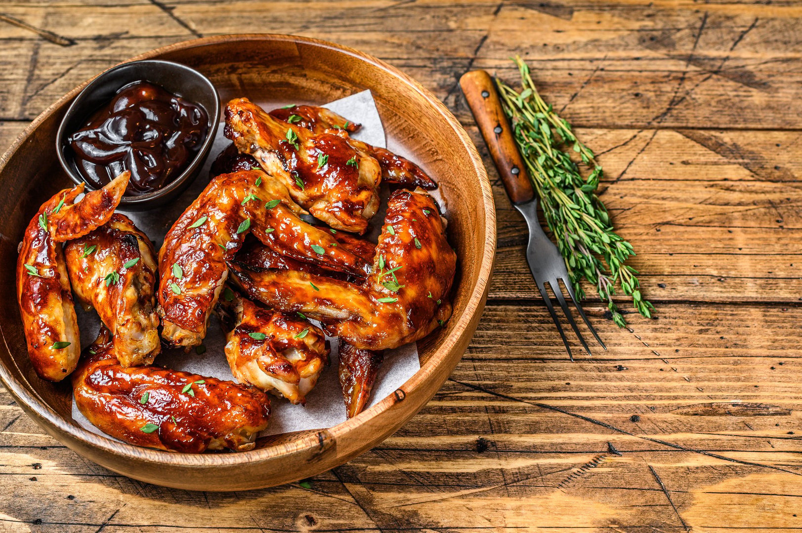 Grilled chicken wings with bbq sauce. wooden background. Top view. Copy space.