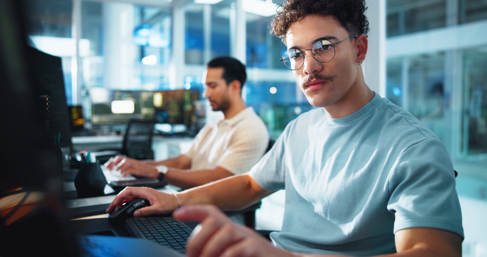 Computer, programmer and glasses with man in office for game designer, coding app and ux update. Software development, research and level gameplay with employee in agency for developer project