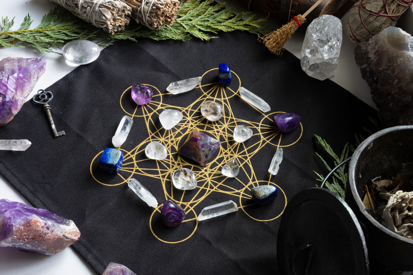 A close up image of a crystal healing grid using amethysts stones and sacred geometry.