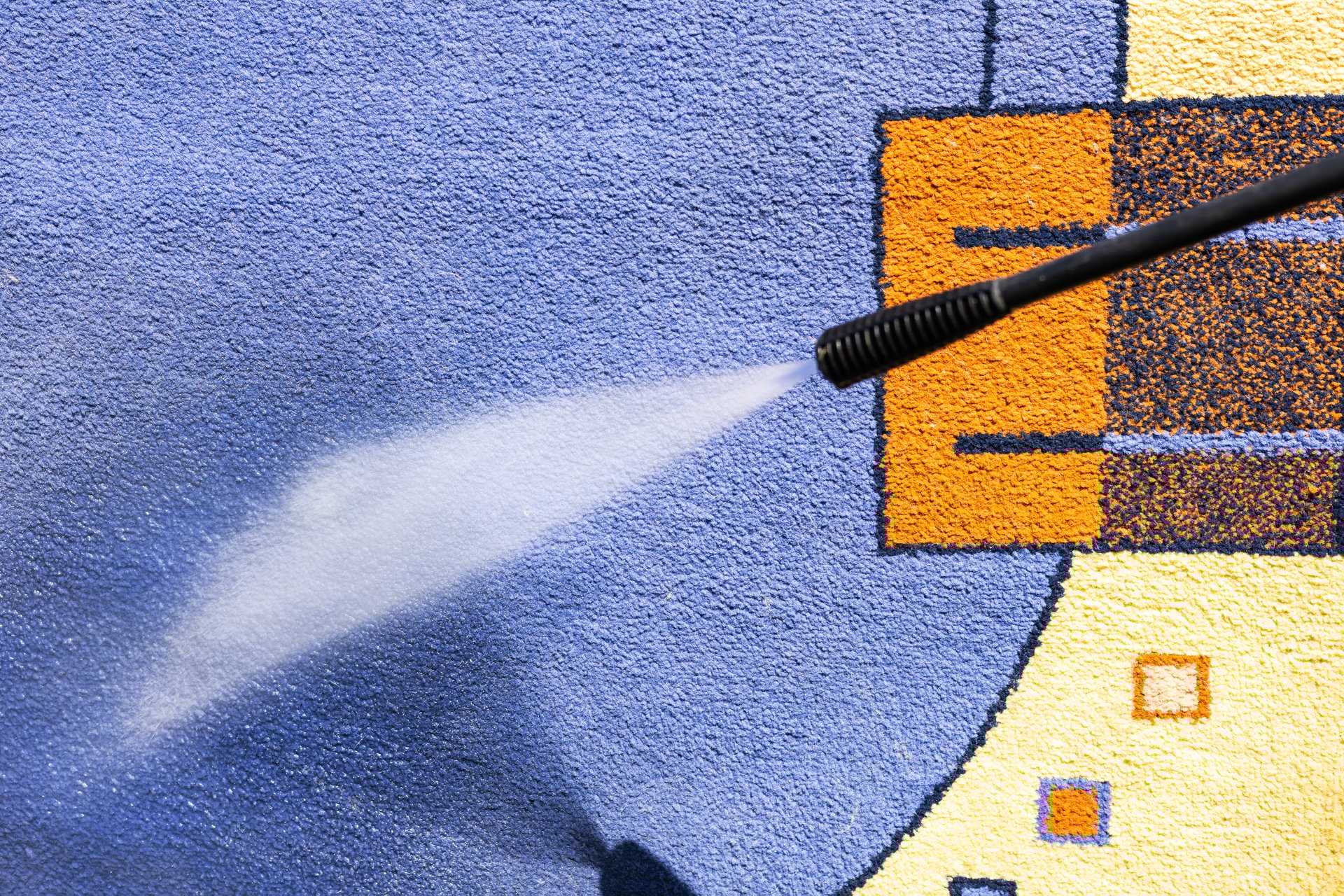 Carpet cleaning with a pressure washer.