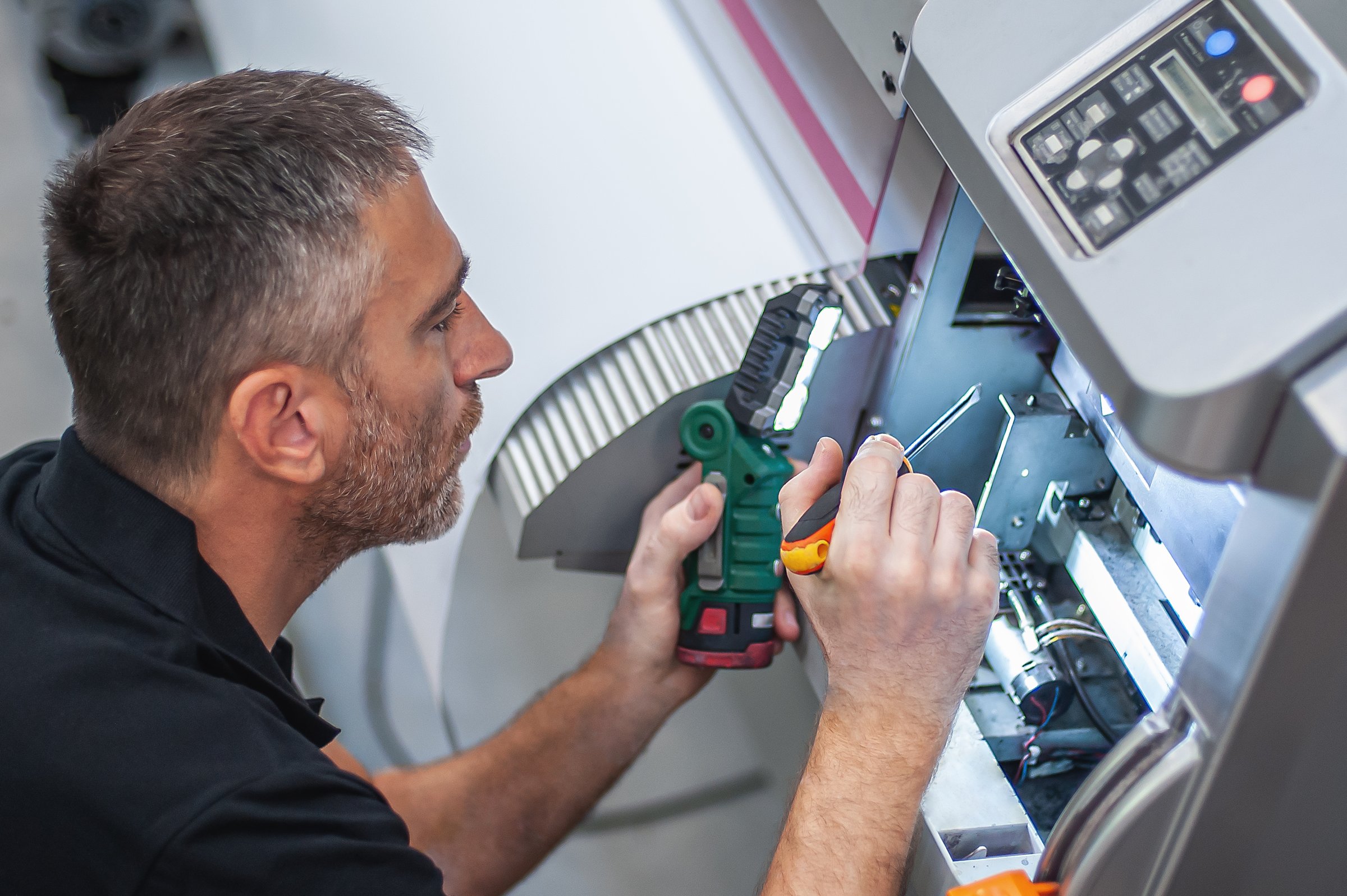 All machines need maintenance. Professional technician troubleshooting and repair the machines in the printing house.