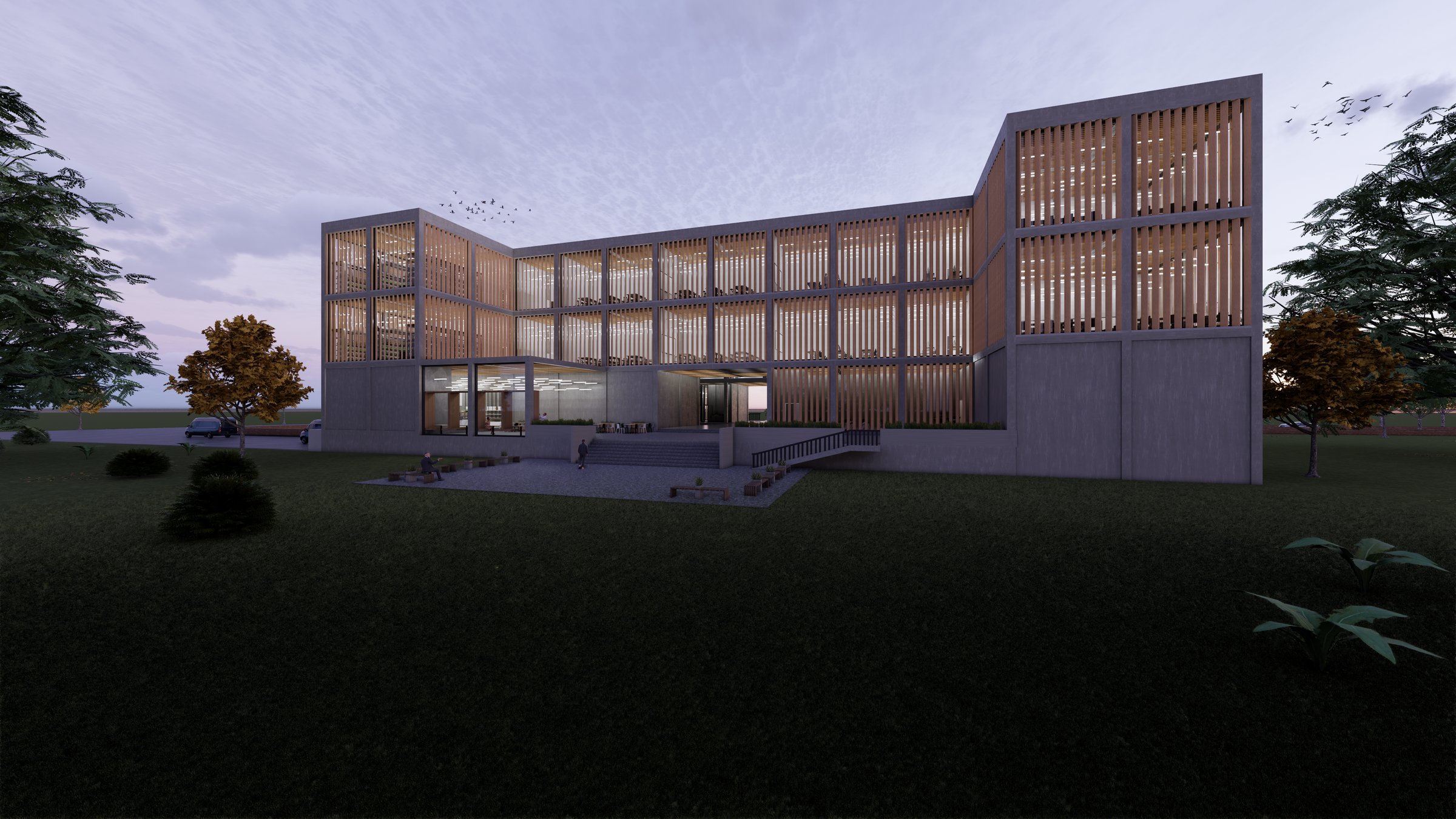 Modern three-story building with wooden slat facade surrounded by trees and a grassy area at dusk.