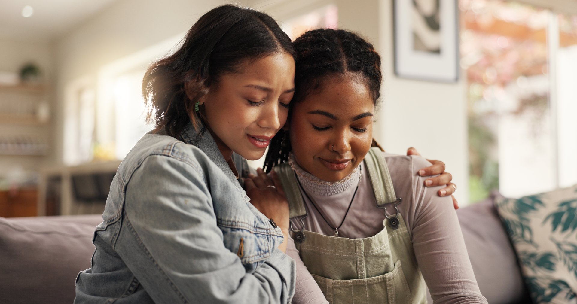 Sad, women and hug with friends on couch for comfort with breakup or relationship fail in home. Support, people and empathy for cheating mistake, console and kindness for mental health in living room