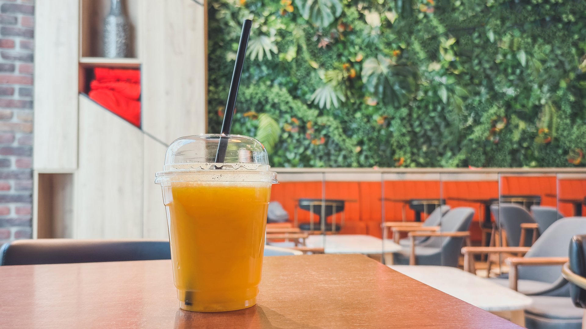 Fresh orange juice with black straw