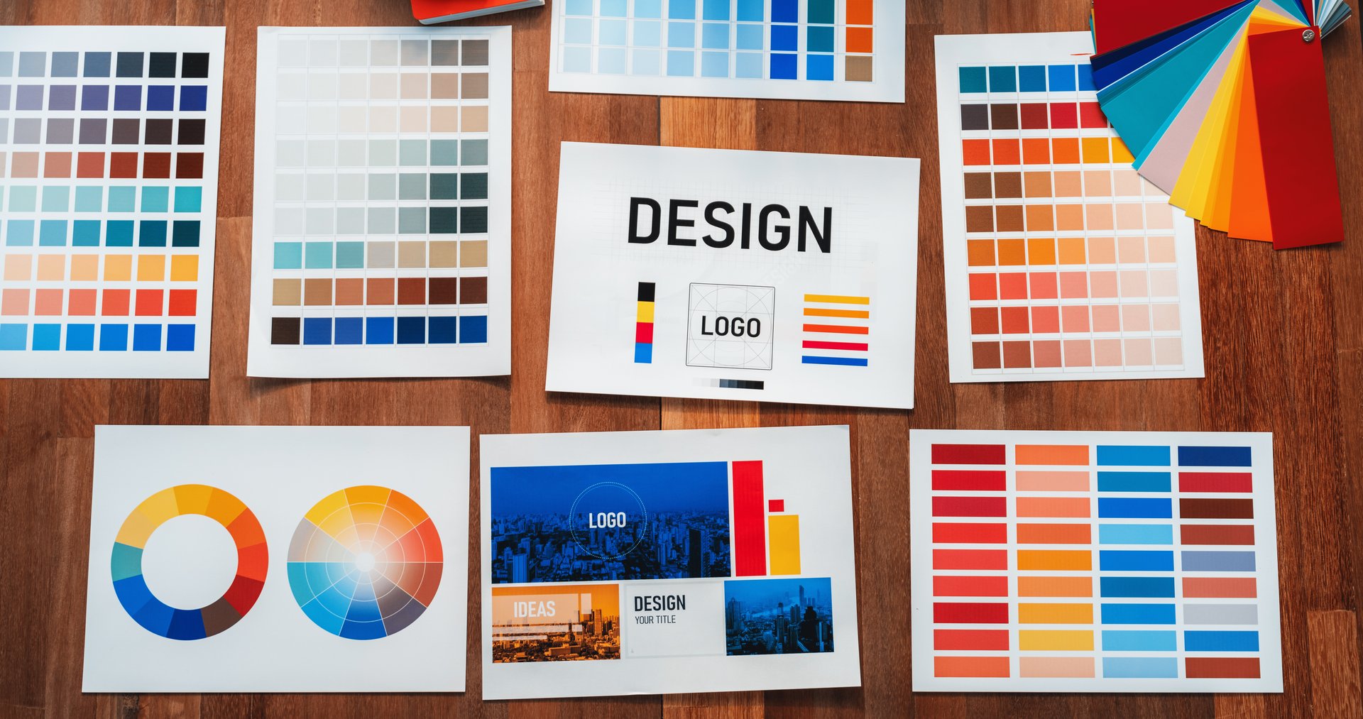 Panorama shot of various color palette idea papers arranged neatly on workspace table for graphic design concept. Color swatches and selection for unique digital art design. Scrutinize