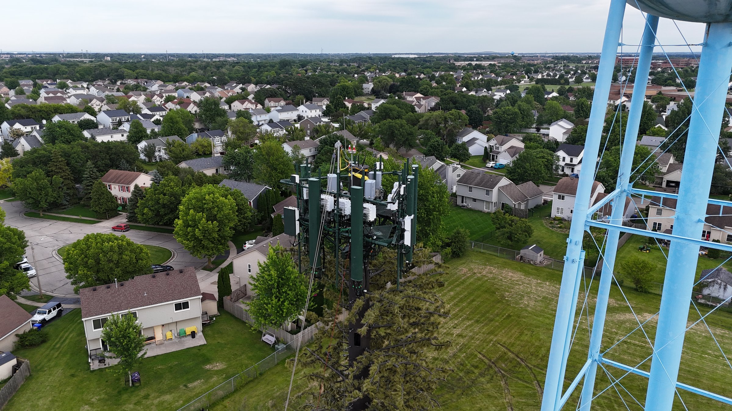 Air View Of A Cell Phone Tower Being Raised Tree look
