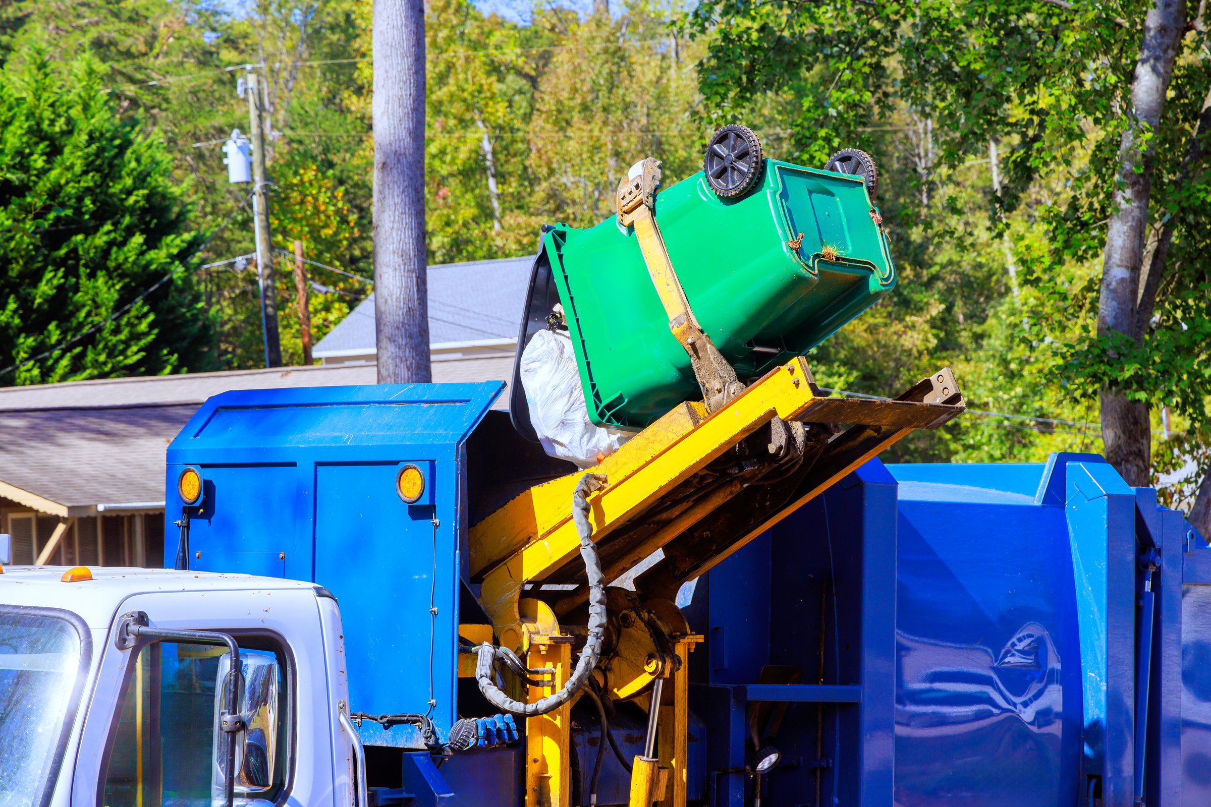 Removal of garbage by municipal cleaning services by loading mixed household waste into garbage trucks
