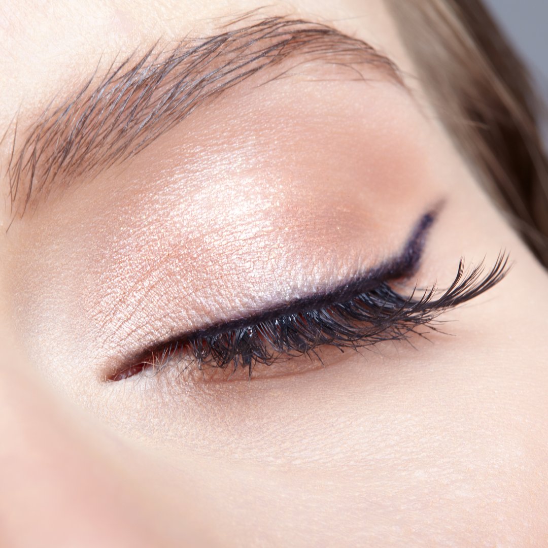 Closeup macro shot of  human female closed eye. Woman with natural vogue face beauty makeup. Girl with perfect skin and  light pink  eyes shadows.