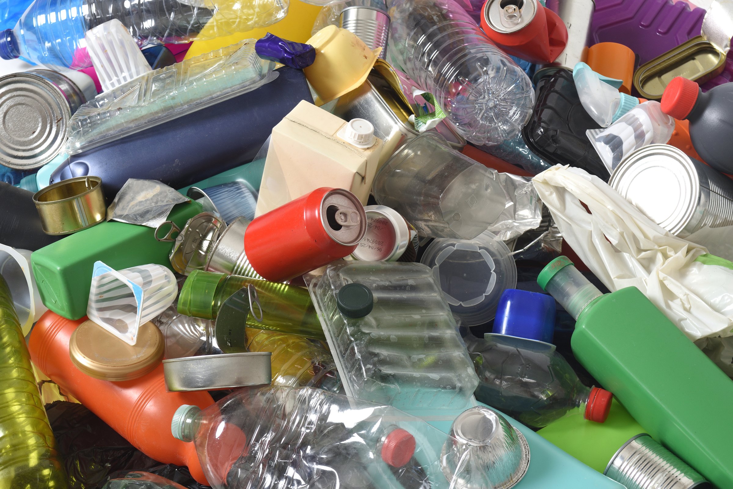 full frame of trash plastics and cans on white background