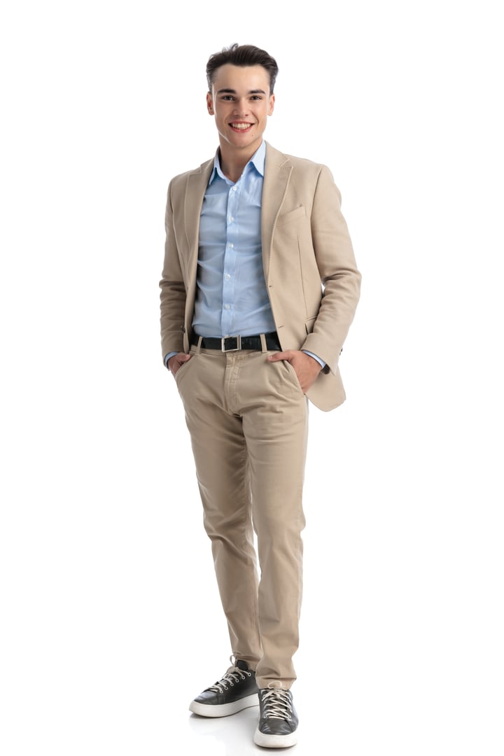 attractive student in beige suit holding pockets while standing on white background and smiling