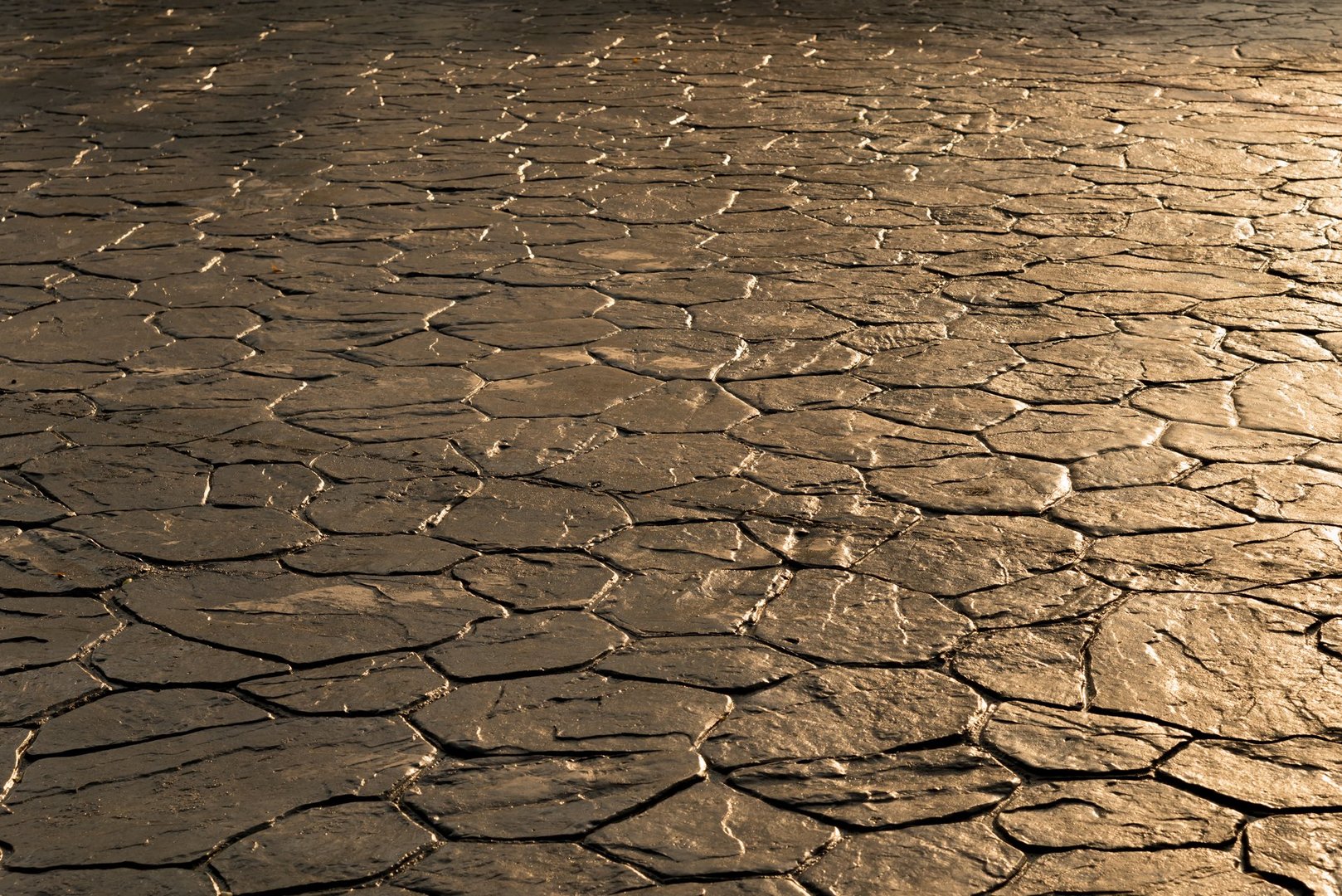 Stamp concrete texture pattern and background, and reflection of sunlight on the floor.