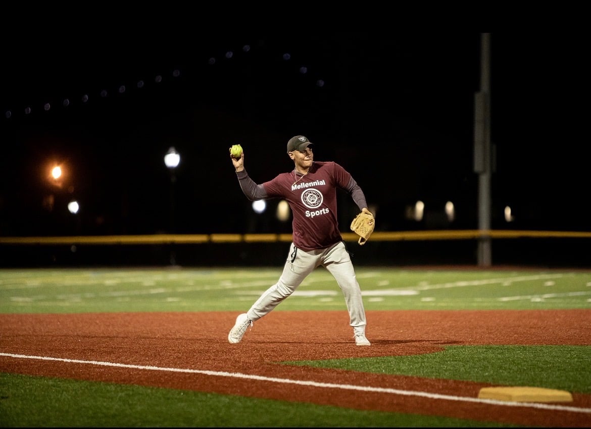 Happy softball players celebrating with high fives after winning game