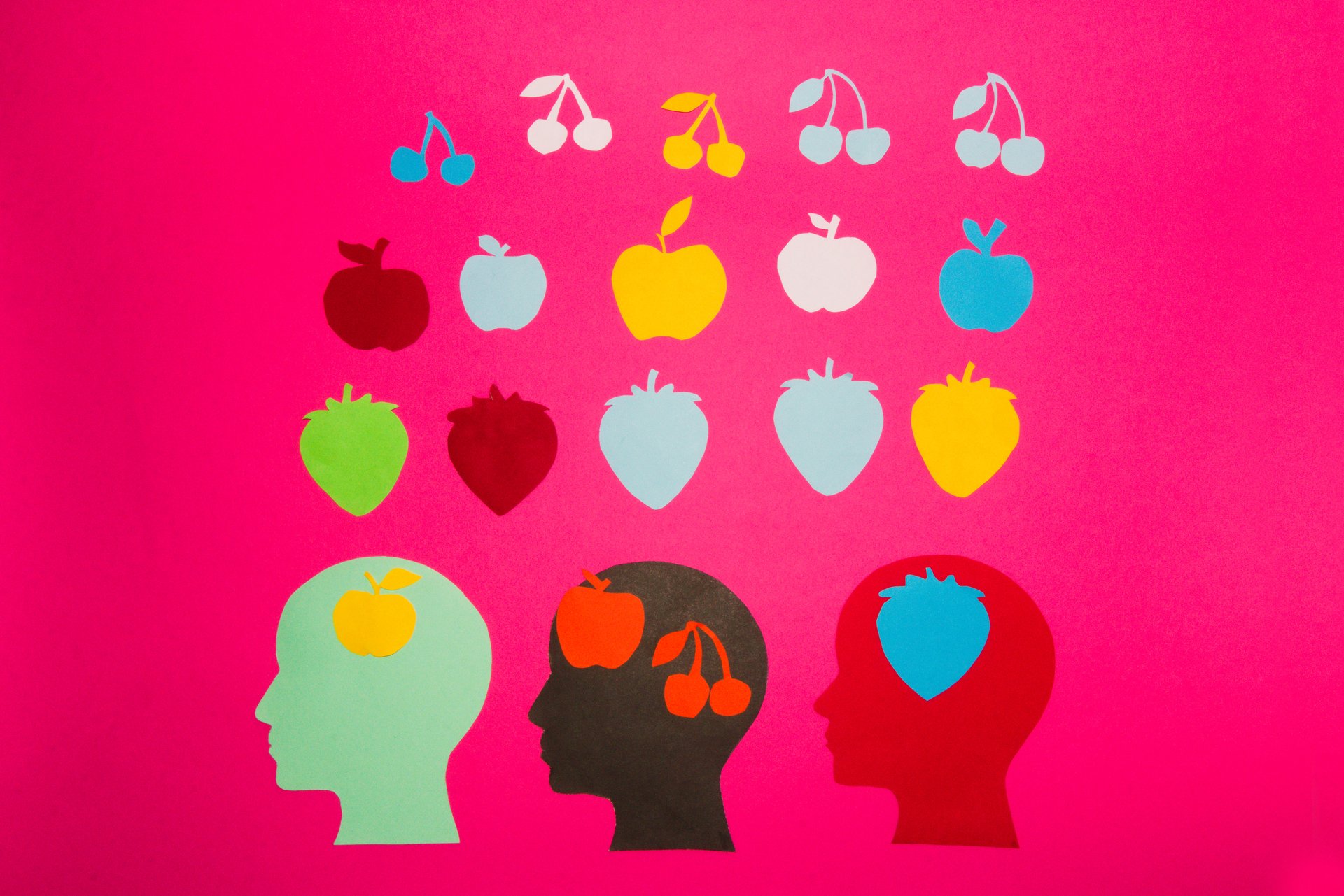creative concept of fruit on a pink background that represents information on the air, paper head that goes through life, learns and collects information that is useful for his life