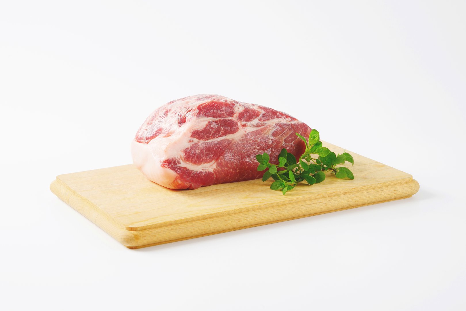 raw pork meat on wooden cutting board
