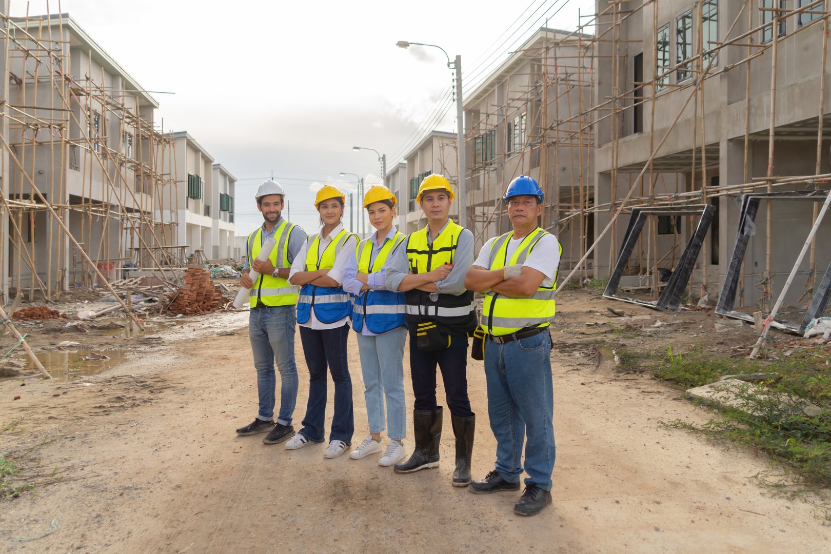 A group of workers, a designer team talk, communicate, discuss, and working on industrial construction site at home architecture building project. People lifestyle.