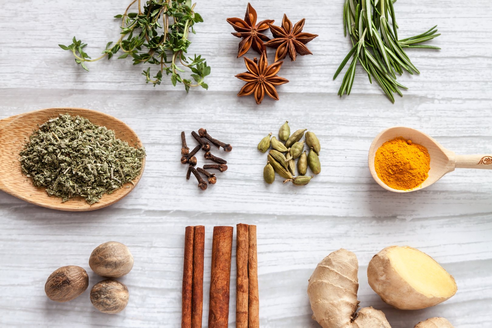 Top view antivirus health food knolling immune boosting properties with rosemary, thyme, nutmeg, sage, clove spice, ginger, cinnamon sticks, turmeric, star anise, cardamom herbs. Immune defense healthy products concept