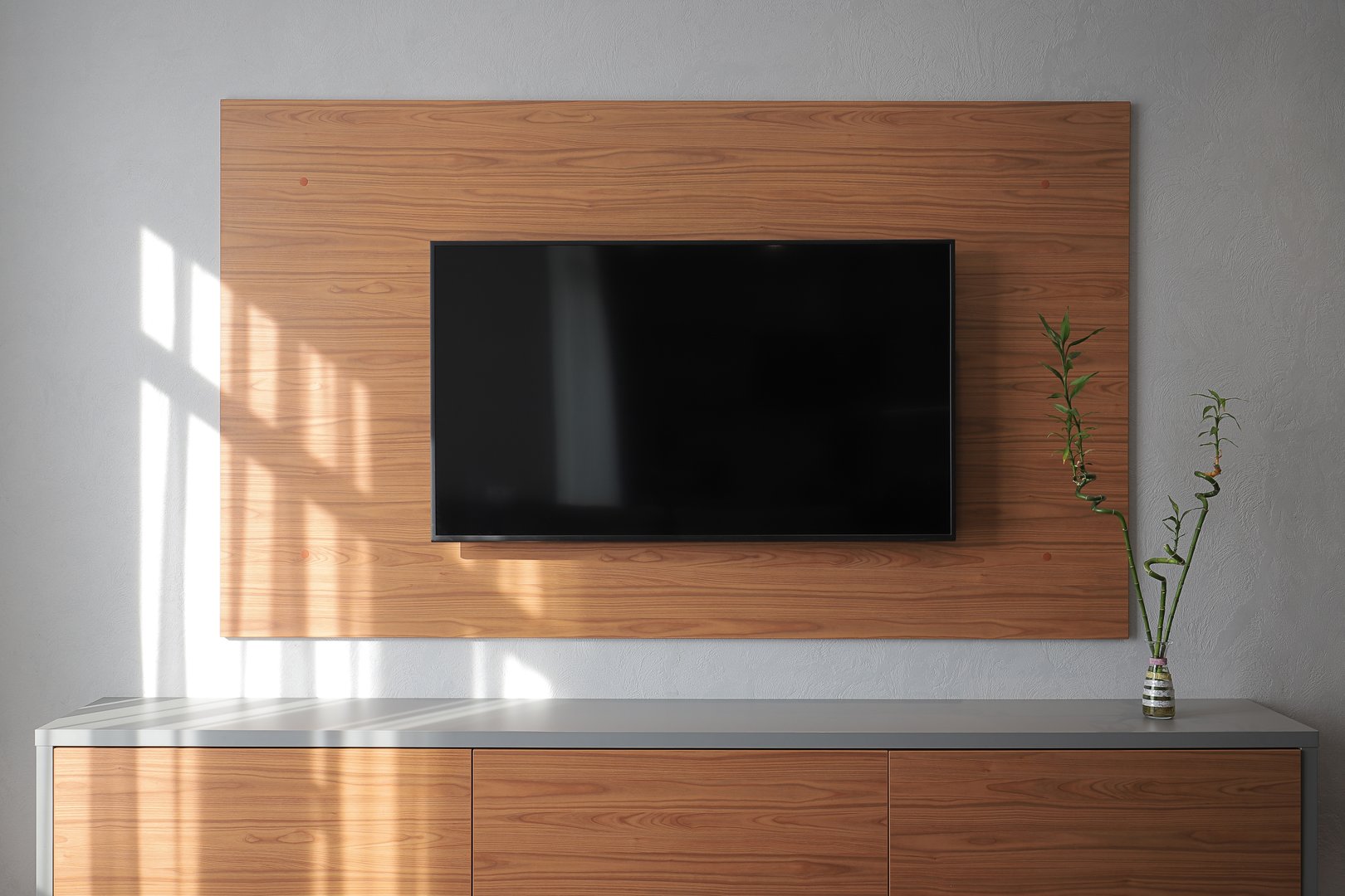 Large TV on a wooden panel on the wall in the living room