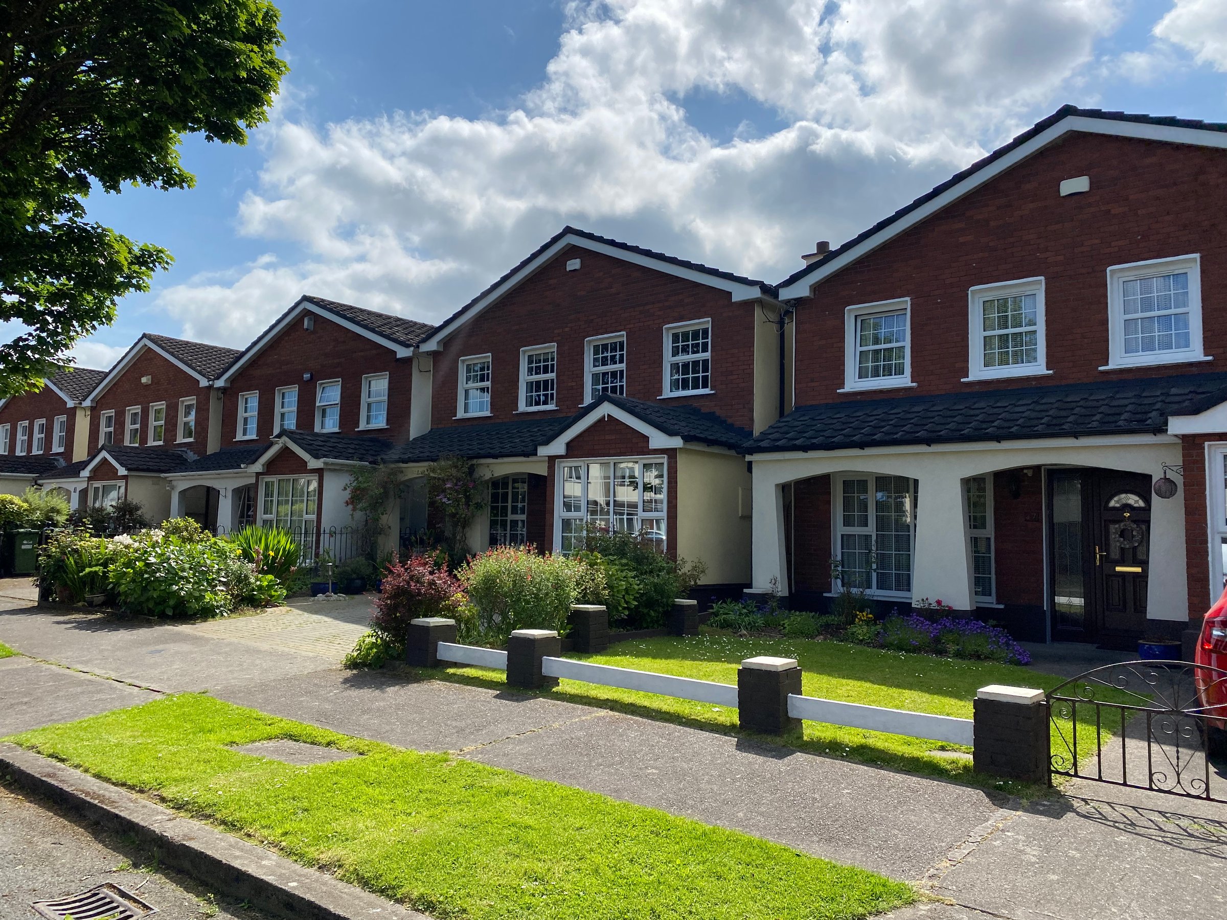 Beautiful repeating identical houses. Private houses. Housing for a family. Acquisition of real estate. Beautiful nature in Ireland. Relaxation vacation in summer.