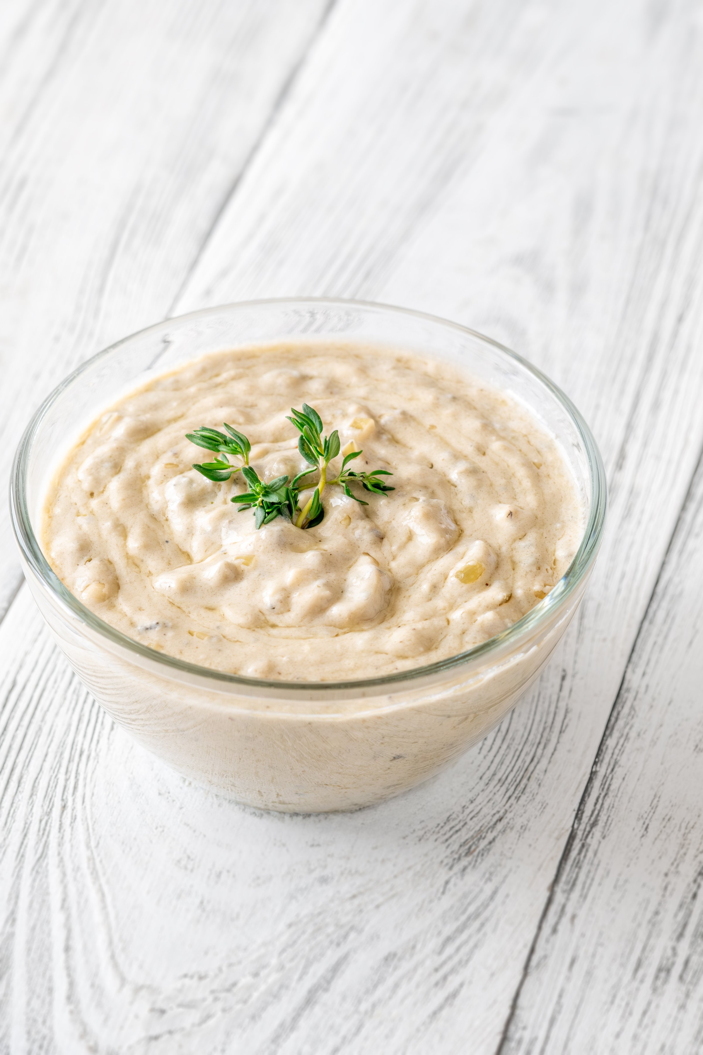 Herbed sauce glows softly as thyme floats atop rich, tangy blue cheese