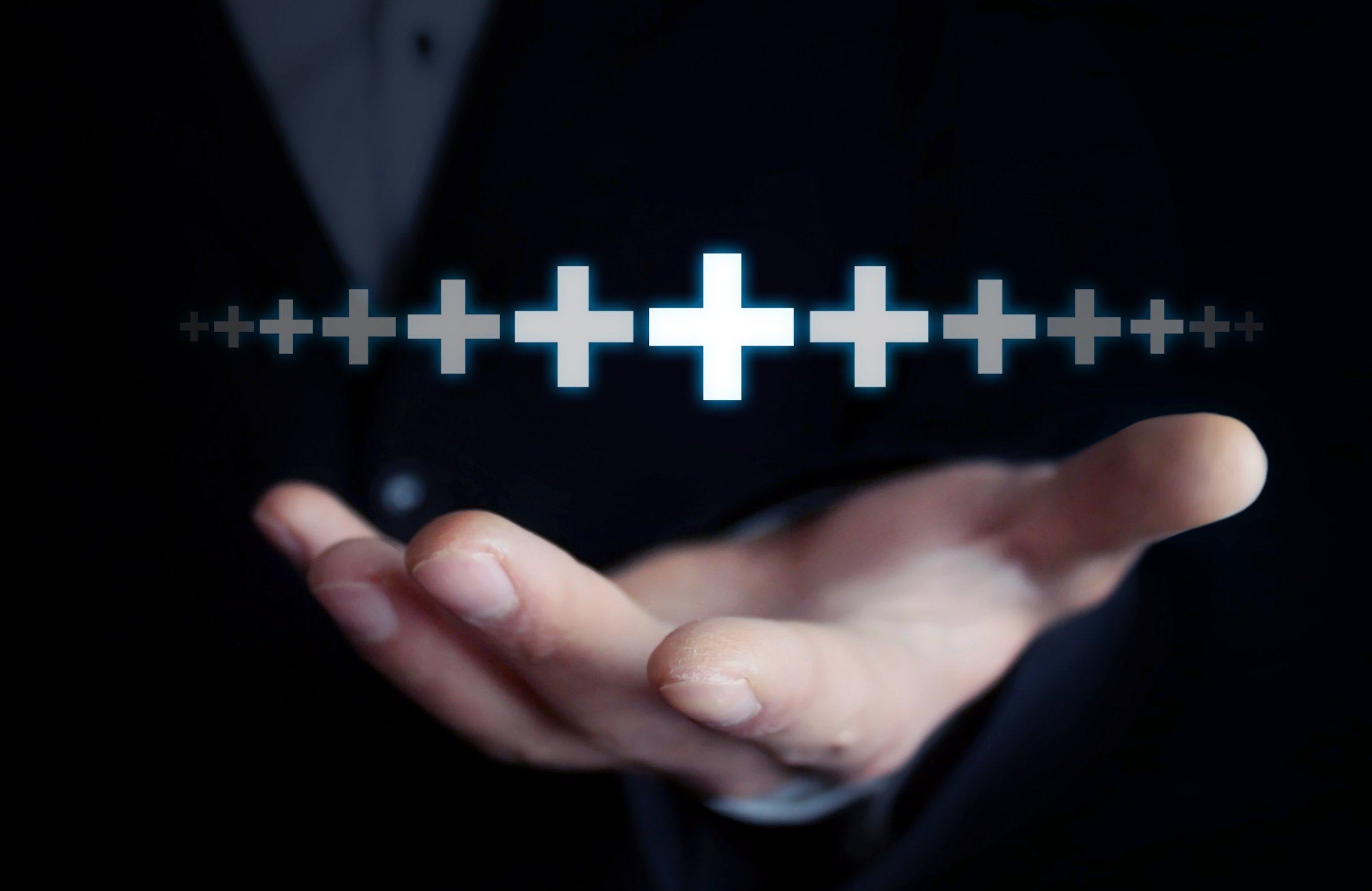 Man showing plus sign.