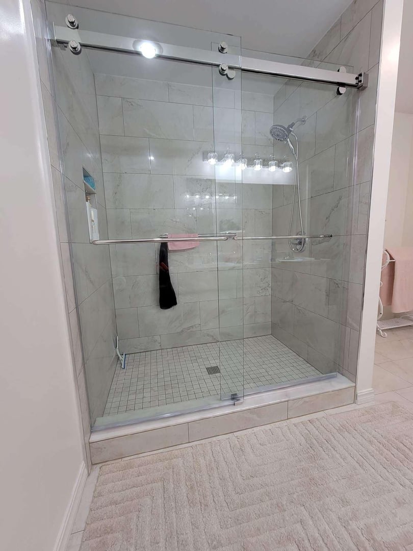 Sliding shower door with satin hardware finish
