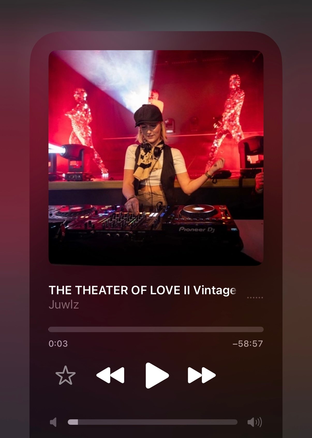DJ performing in a club with colorful lights, surrounded by DJ equipment. Album title: THE THEATER OF LOVE II Vintage by Juwlz.