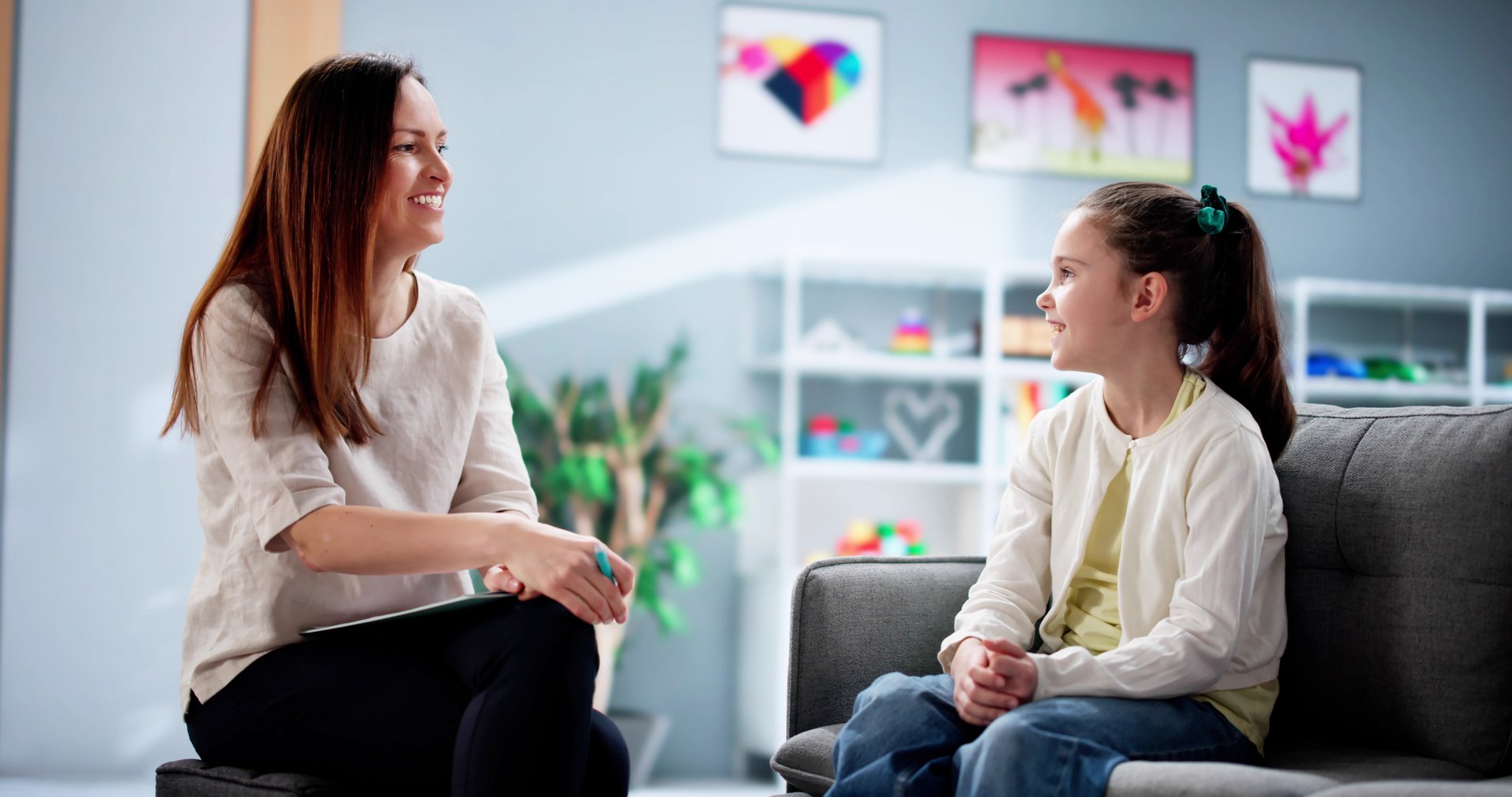Psychiatric social worker provides child treatment and counseling session.