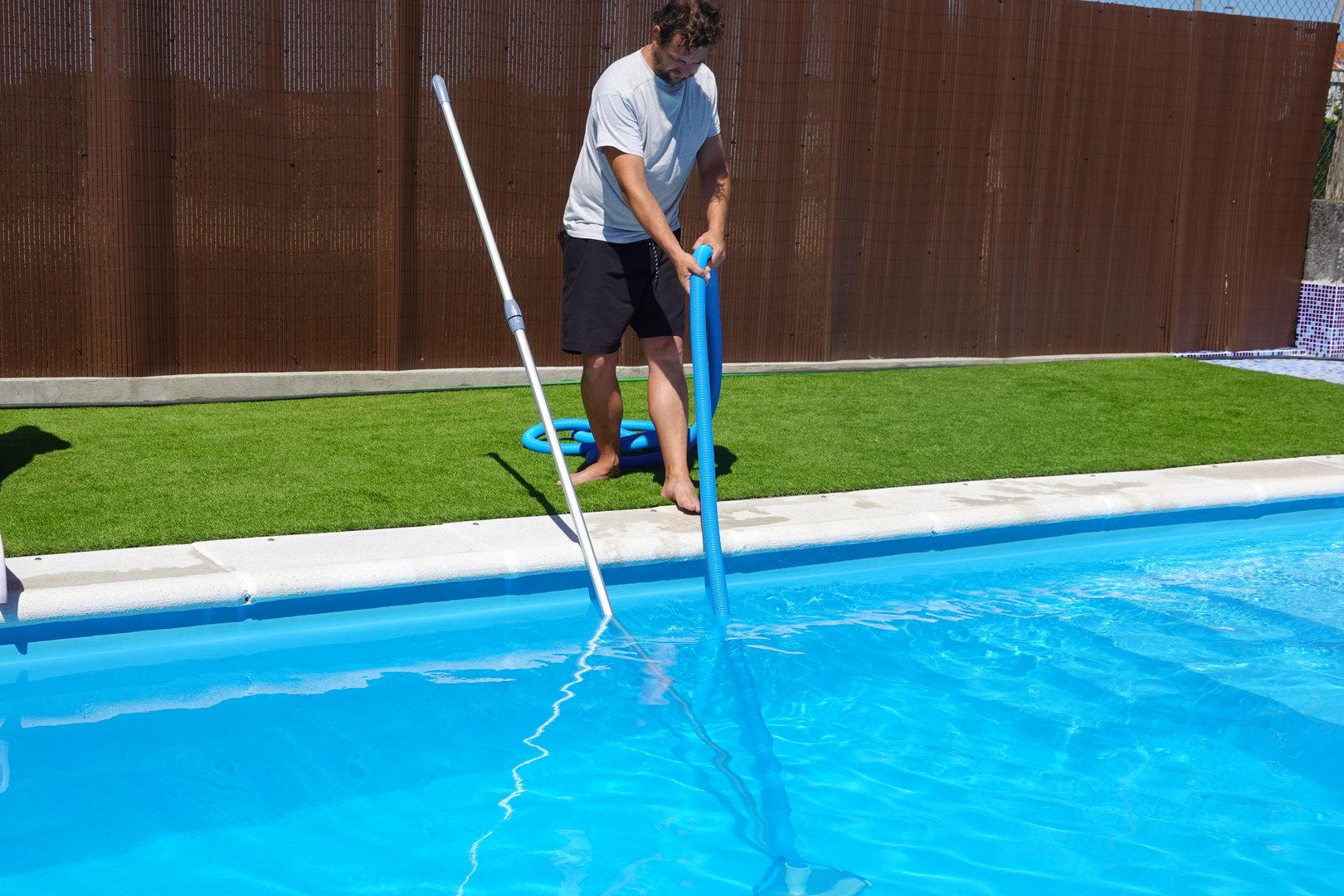 pool cleaner tube holder man, all set to clean pool at home