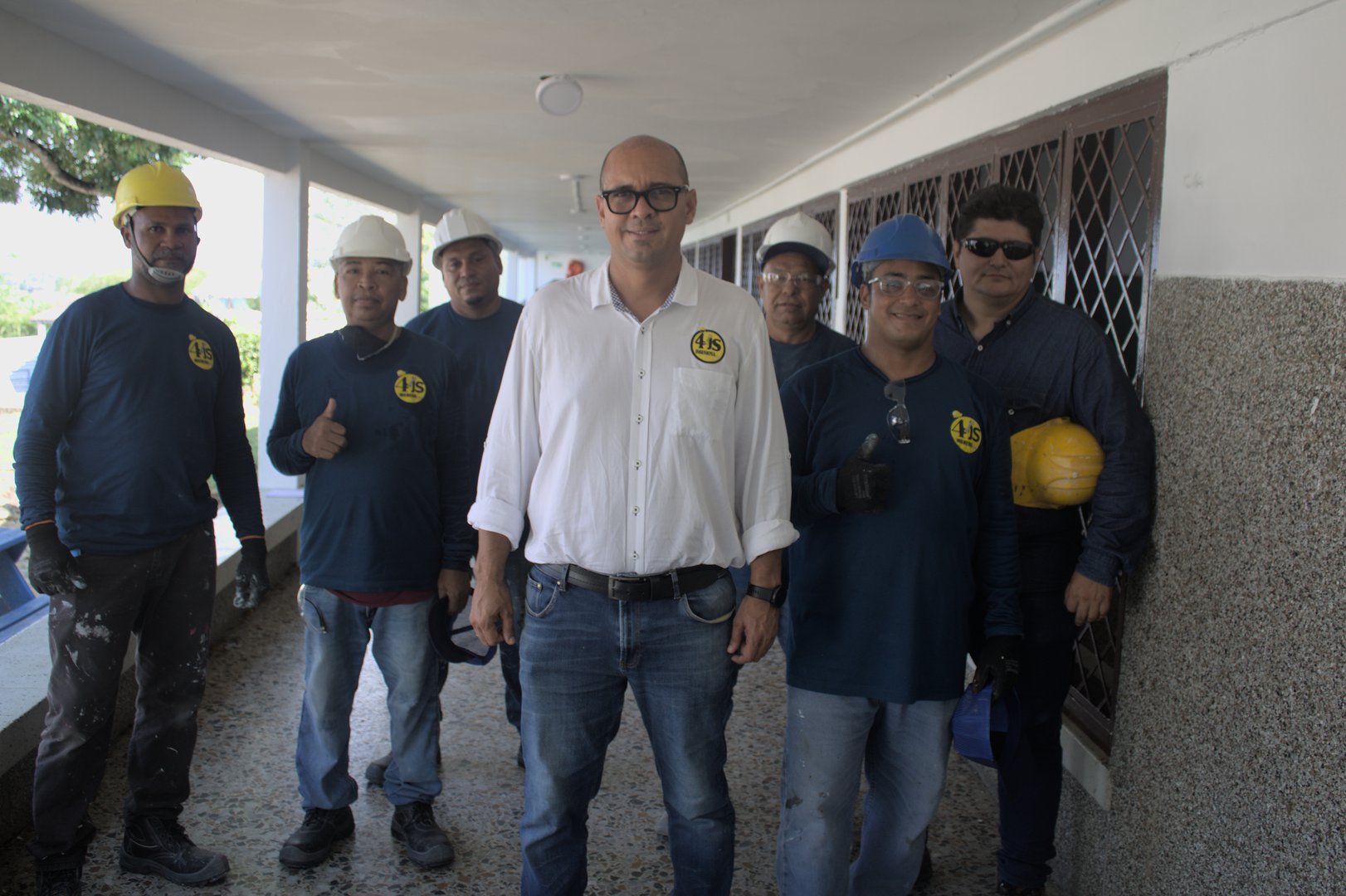 Engineering team collaborating with a laptop during a night shift at a petrochemical refinery.