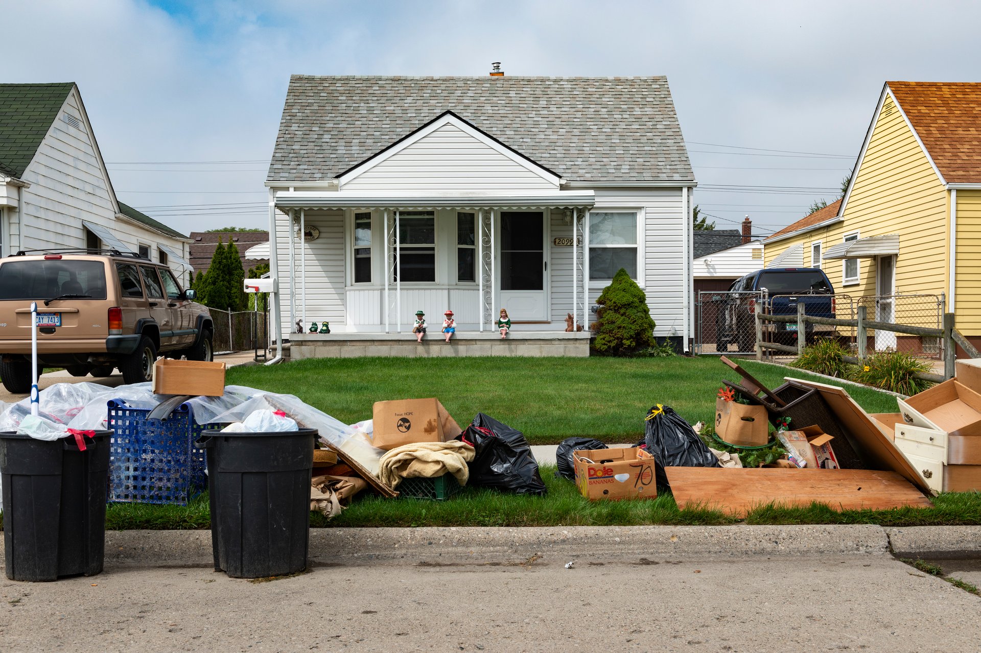 Detroit, Michigan, USA - August 20, 2014: An evicted house at a suburban street with left belongings on the lawns near the 8 mile road, in the city of Detroit.