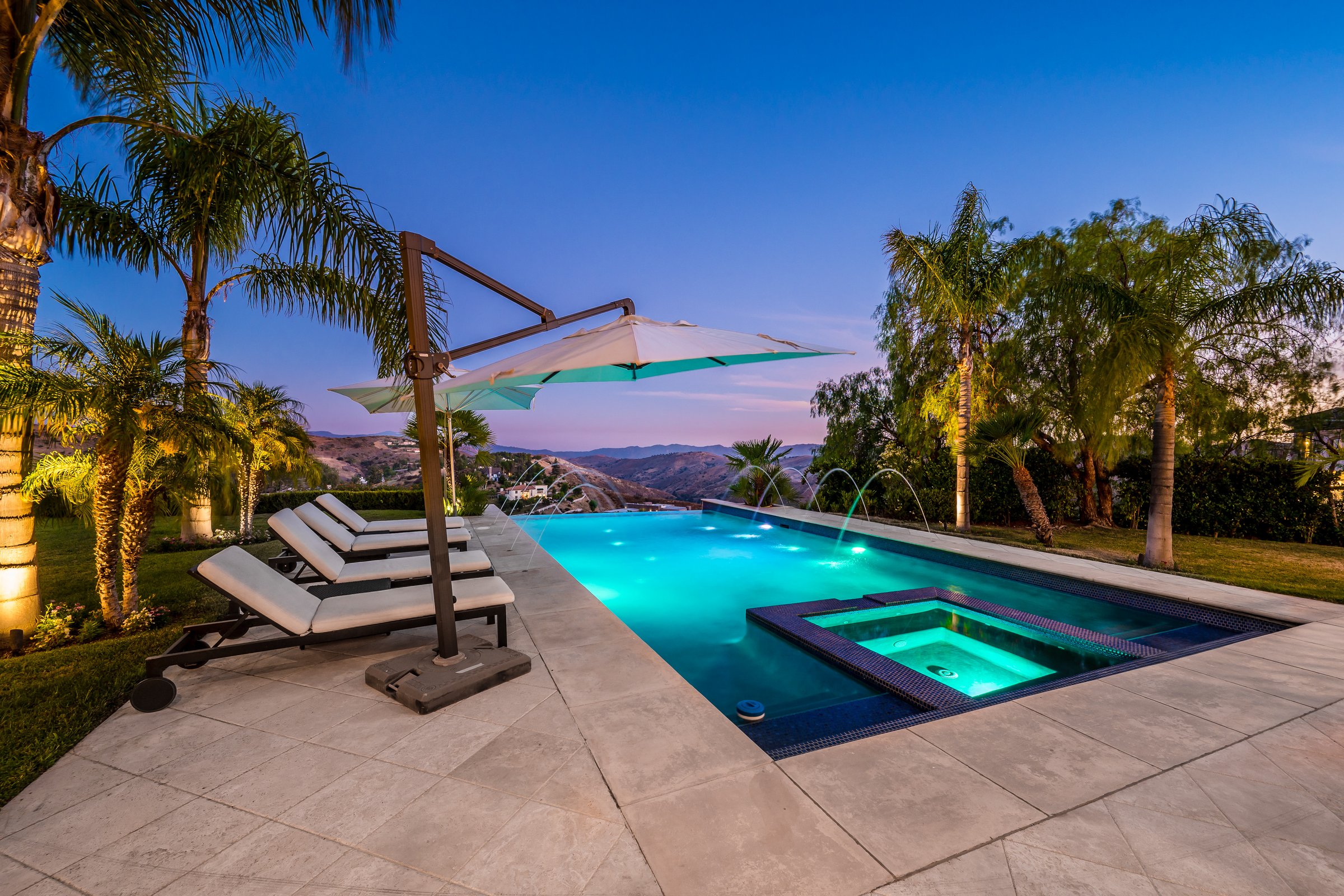 A stunning poolside area with pristine white lounge chairs