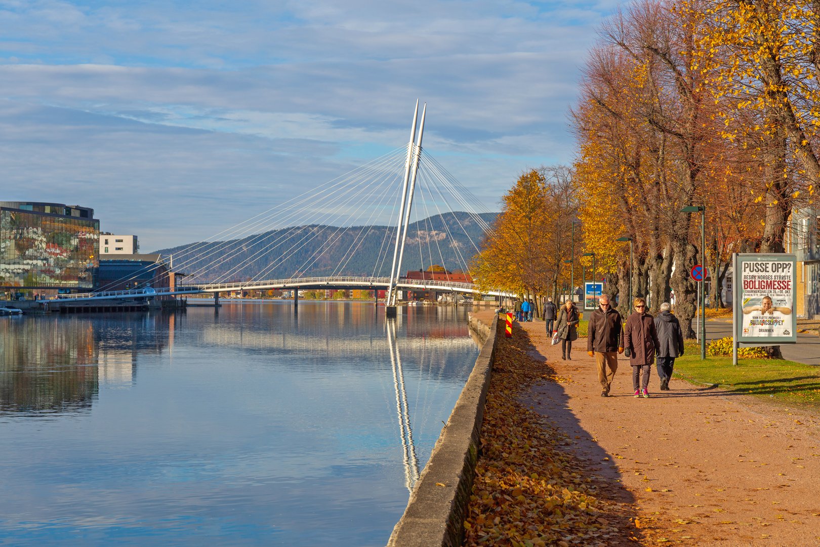 Drammen, Norway - October 30, 2016: People Walking at River Bank Calm Autumn Day in Drammen, Norway.