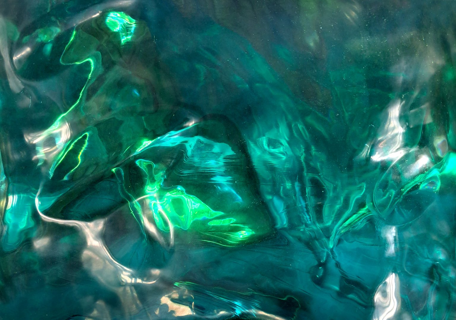 Green tosca emerald stone contour, reflection. and refraction. Refractive effects from light dispersion on the gemstone surface.