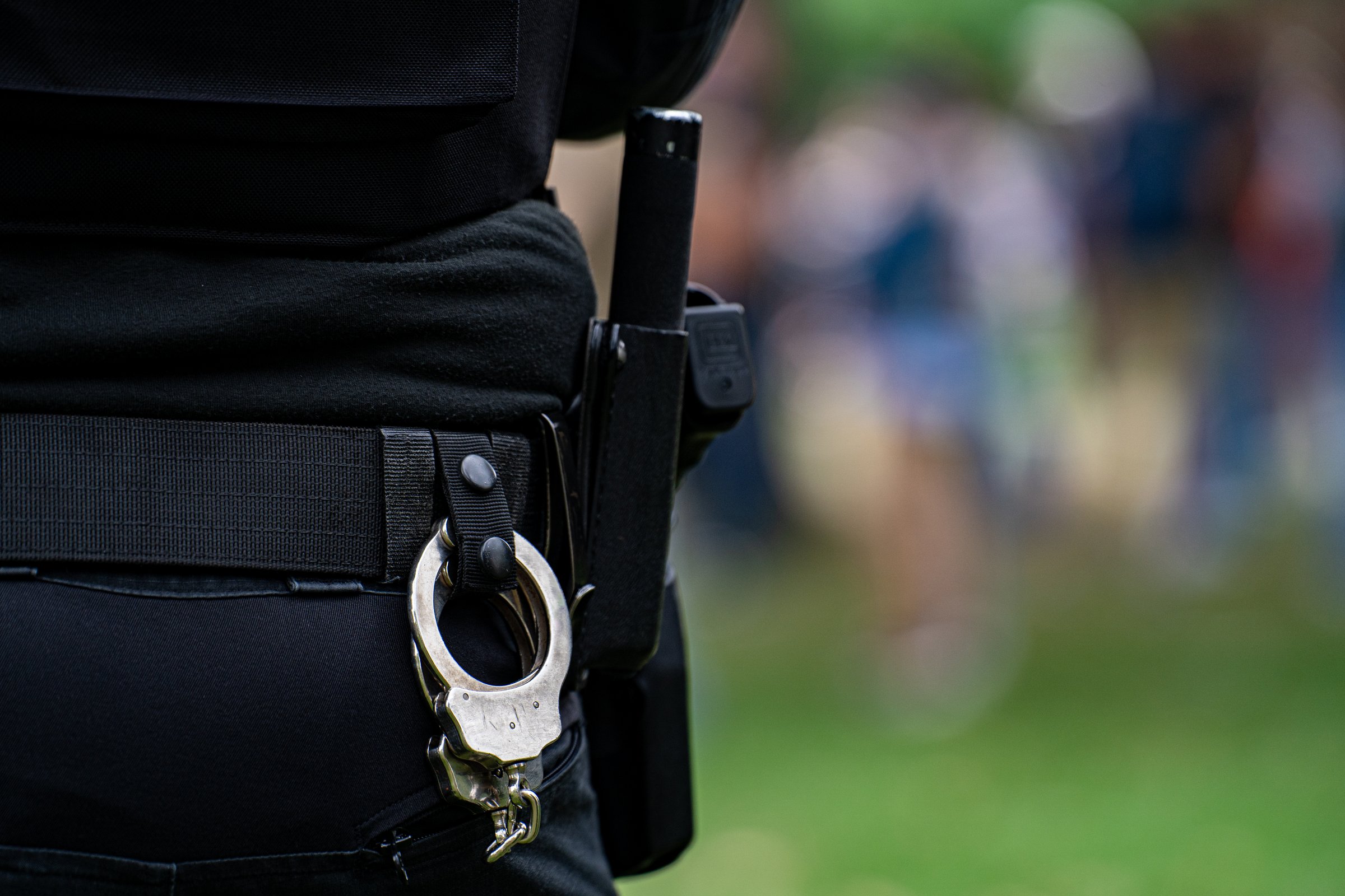Close up of police handcuffs on duty belt.