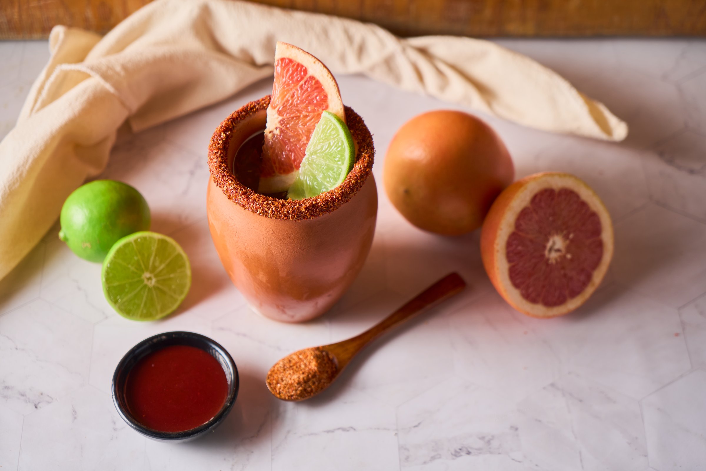 Cantarito, a Mexican drink from the state of Jalisco, made from tequila and grapefruit soda, citrus fruits, ice